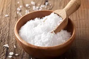 Salt in a wooden bowl with scoop