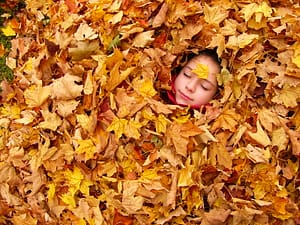 Girl in leaf pile